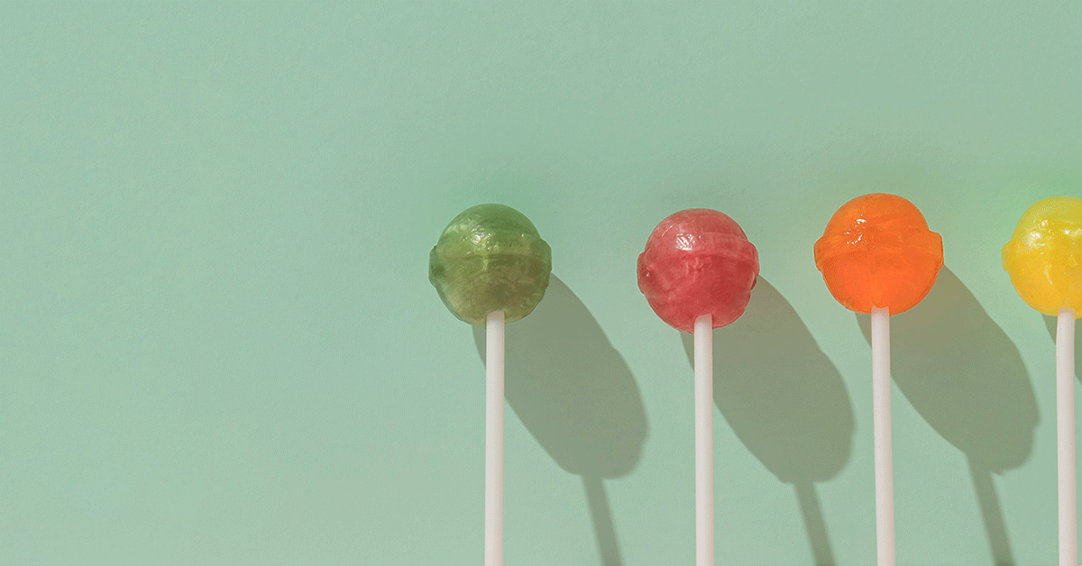 a collection of unwrapped lollipops in various colors
