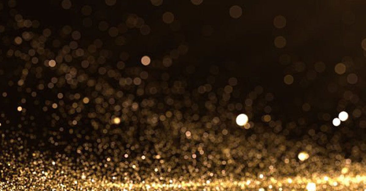Golden sparkles on a black background.