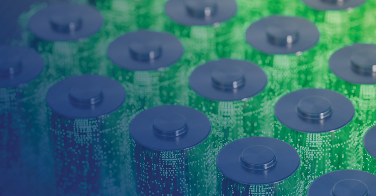 Close-up image of multiple blue and green cylindrical batteries arranged in several rows.