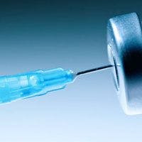 A blue syringe is being inserted into a needle.
