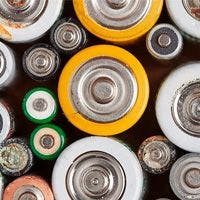 Top view of various types and sizes of batteries crowded together, showcasing a mix of colors and conditions.