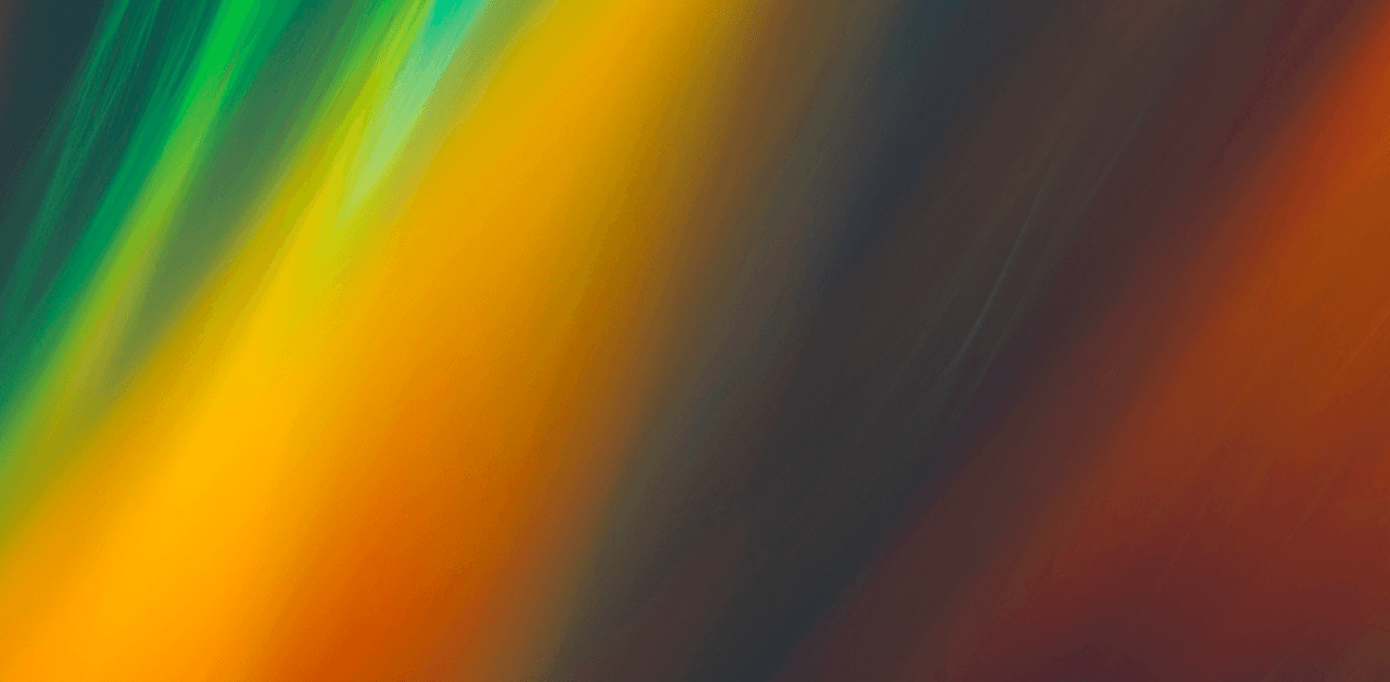 Abstract image with vibrant streaks of yellow, green, and orange blending into a dark background.