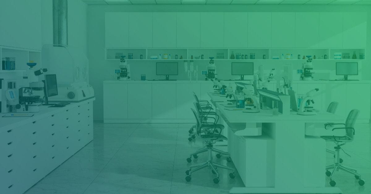 A modern lab filled with microscopes, computers, and organized shelves, featuring white cabinetry and bright lighting.