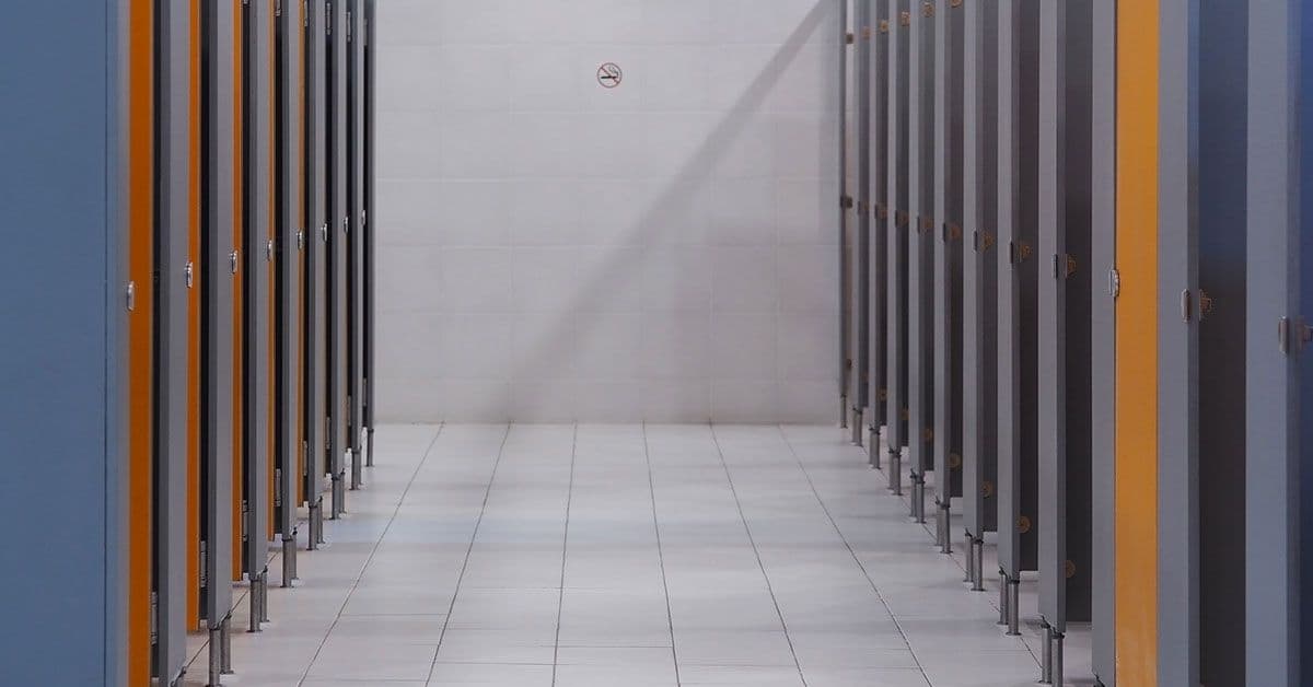 A row of toilet stalls in a public restroom.
