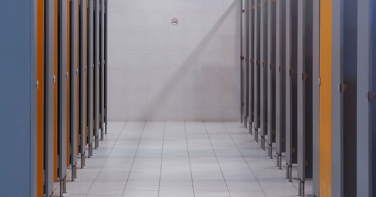 A row of toilet stalls in a public restroom.