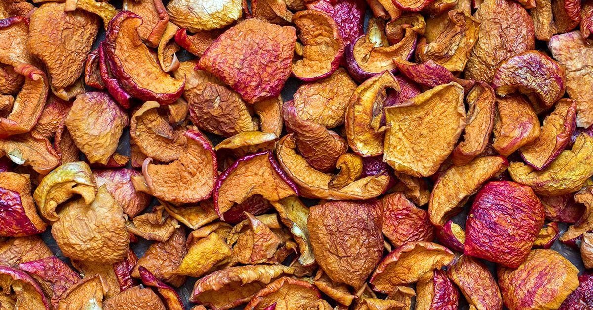 A bunch of dehydrated apple slices displayed across a surface.