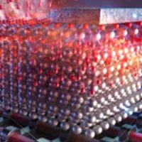 An image of a machine with red balls on it.