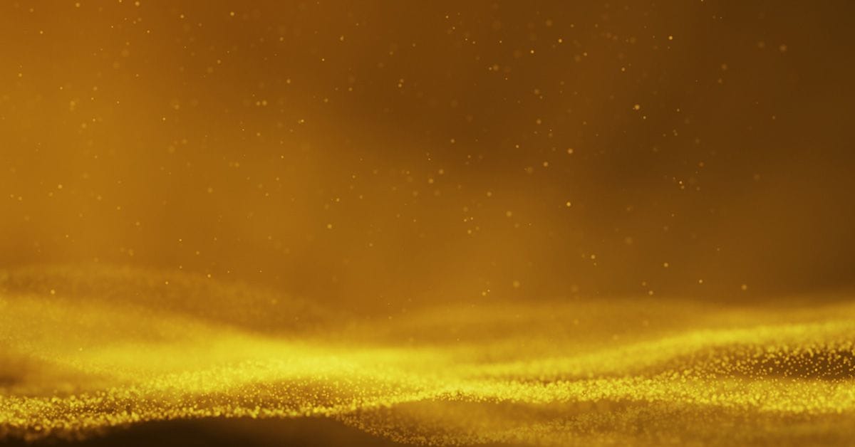 A close-up of flowing golden particles and shimmering lines against a dark background, creating a sense of depth and movement.