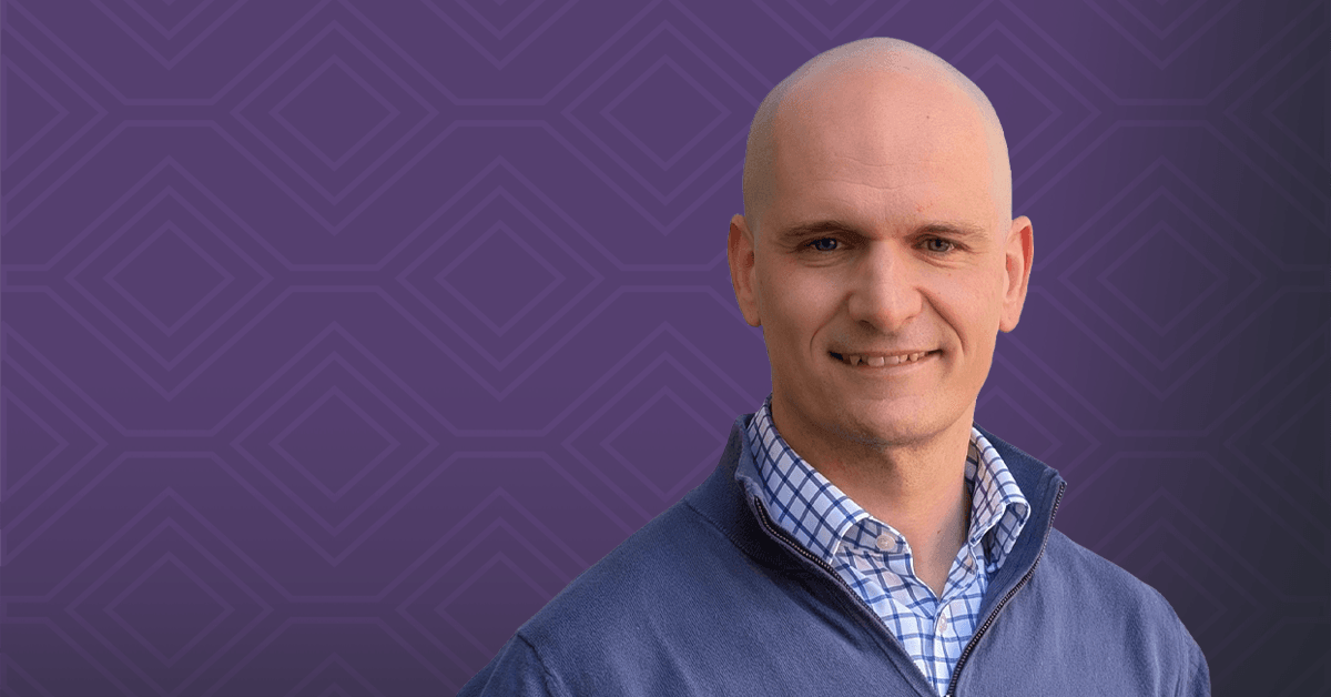 A headshot of Prof. David E. Olson against a patterned purple background