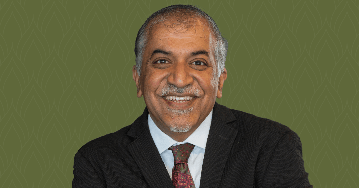 A headshot of Dr. Abhay Pandit, set against a dark green background.
