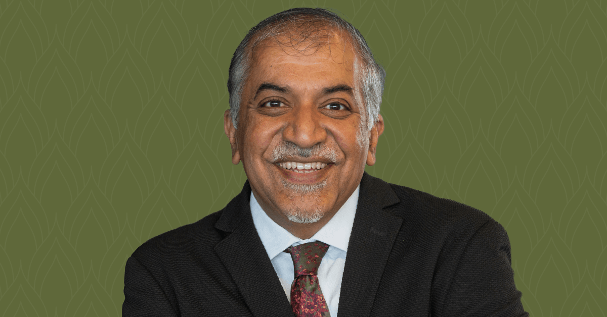 A headshot of Dr. Abhay Pandit, set against a dark green background.