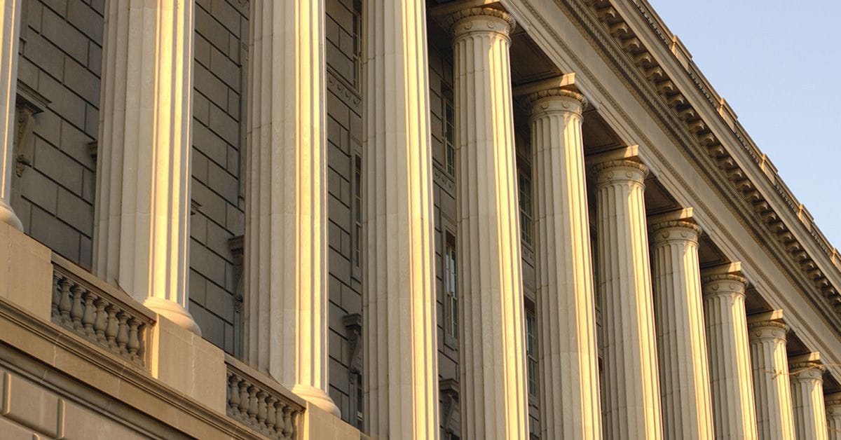 An image of a low angle view of columns on the outside of a building