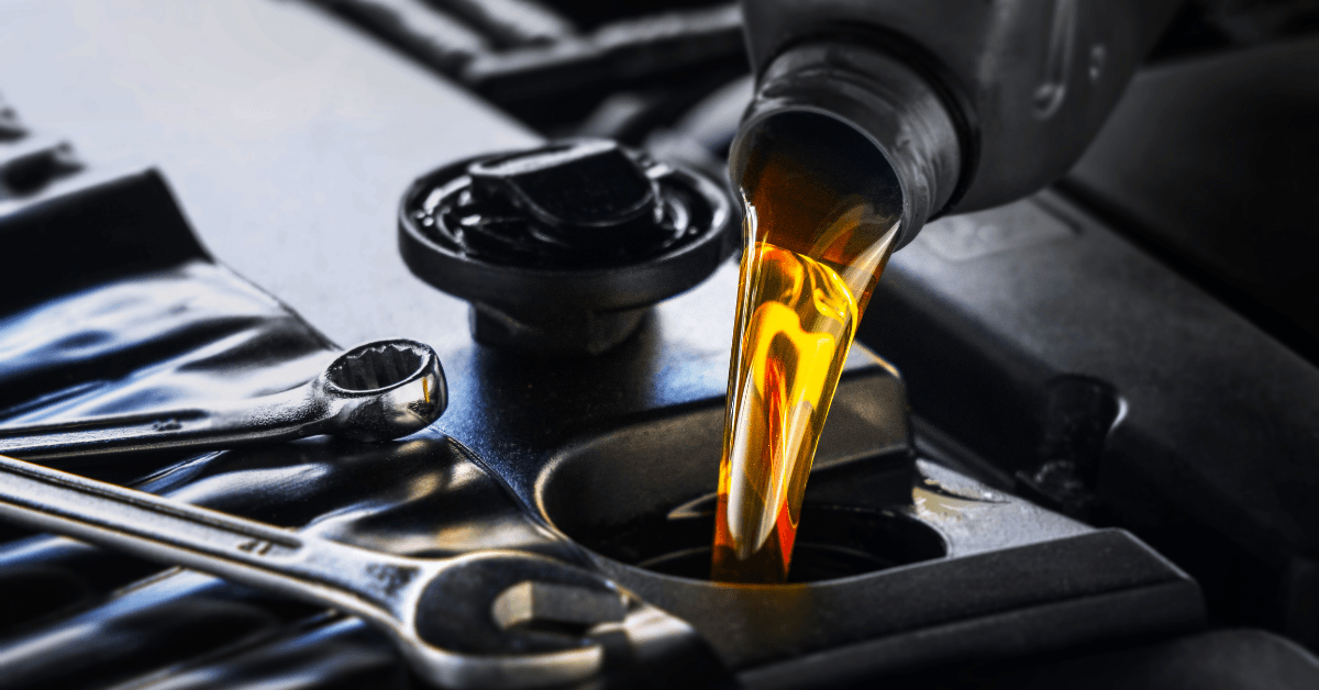 Close‑up of lubricating oil flowing into an engine, illustrating friction reduction, lubrication, and mechanical maintenance.