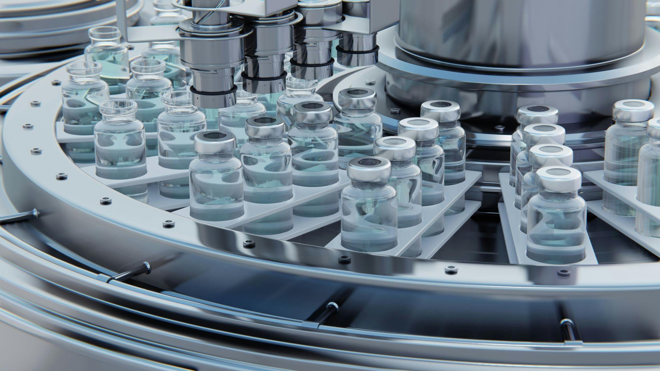 A close-up view of medical vials in a pharmaceutical manufacturing machine.