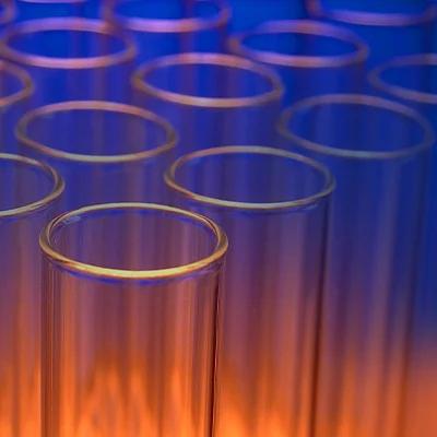a collection of glass vials on an orange and blue background