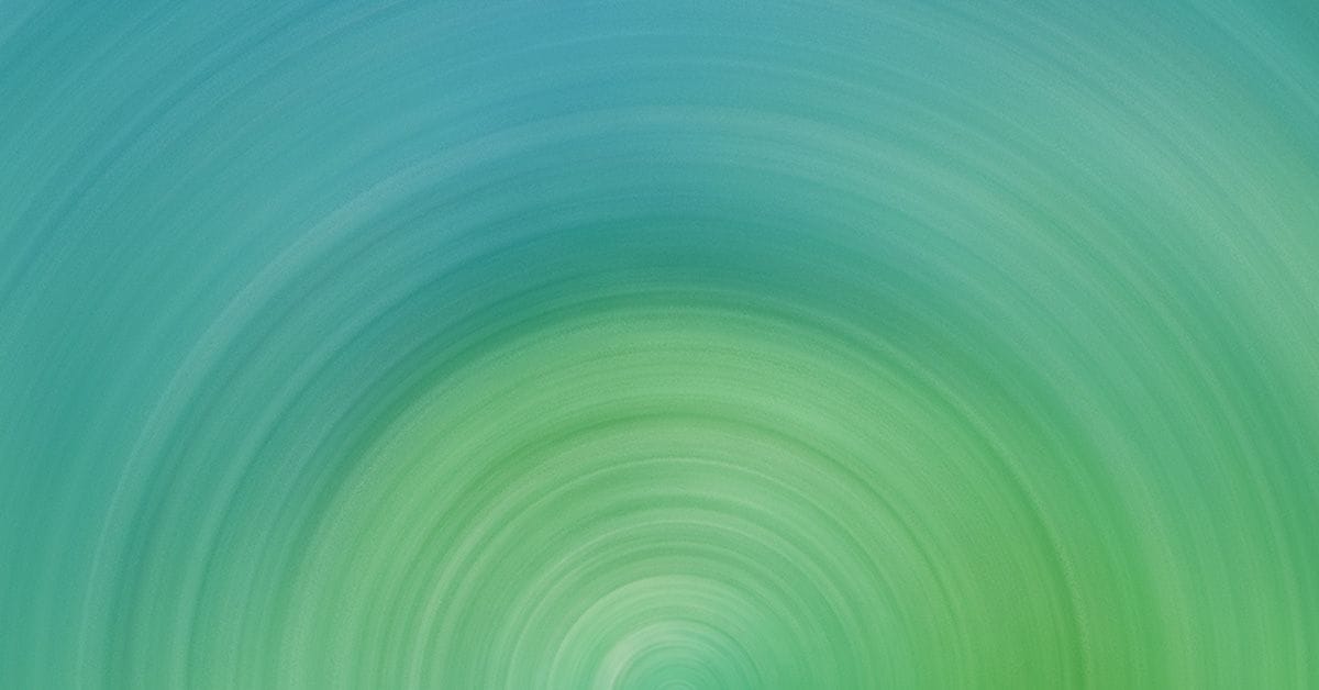 Abstract image depicting concentric circles with a gradient transition from blue to green tones.