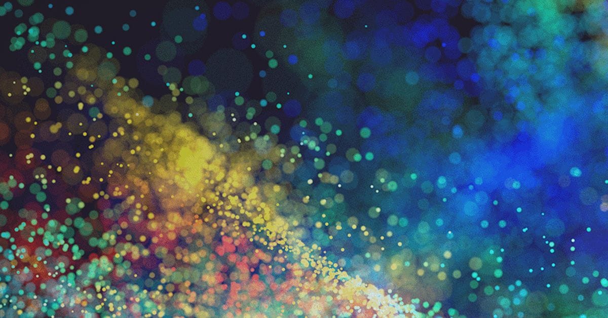 A colorful abstract image with scattered dots in blue, green, yellow, and red hues, creating a dynamic, flowing pattern.