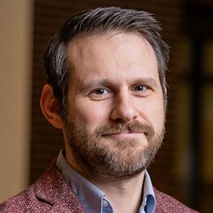 A headshot of Prof. Brett Savoie