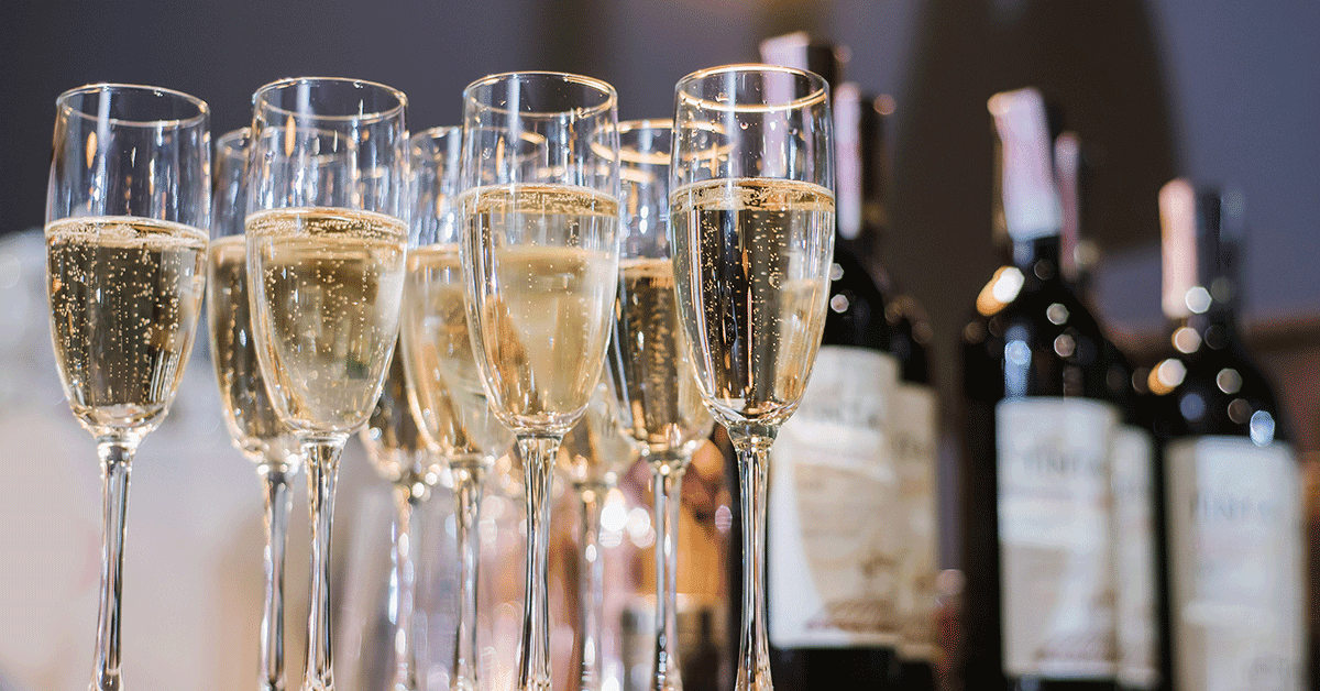 A group of wine glasses lined up on a table.