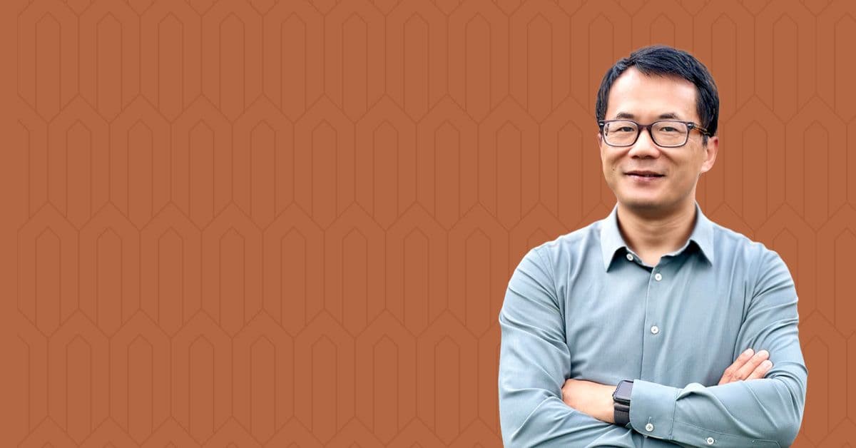 Headshot of Professor Yiying Wu on an orange background