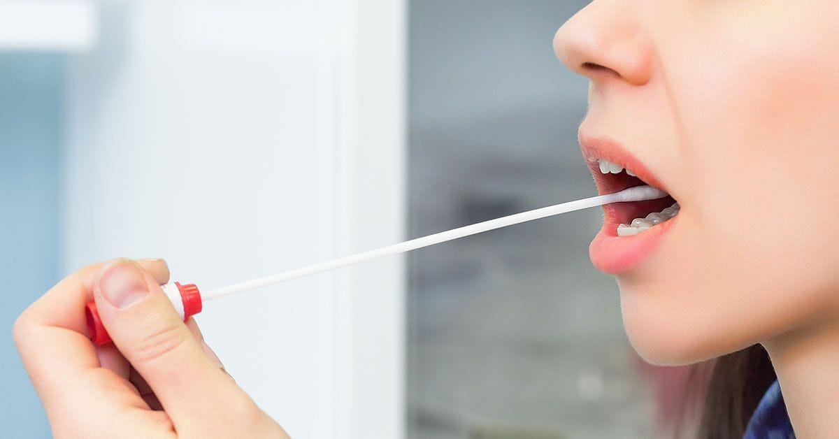 A woman is taking a syringe out of her mouth.