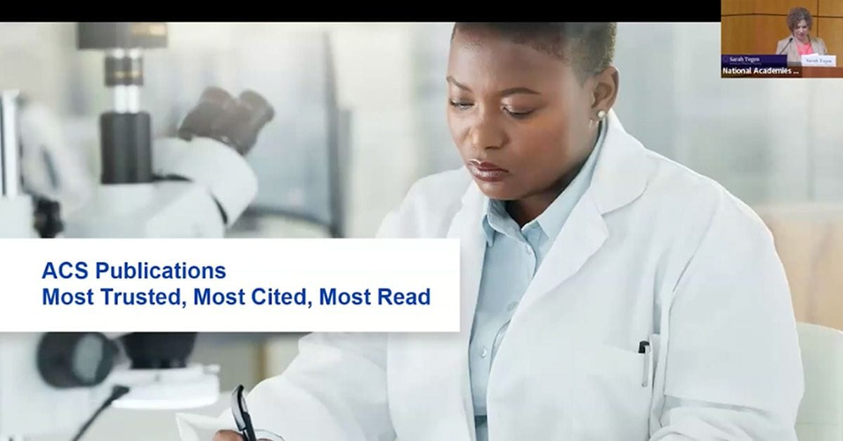 A focused scientist taking notes in a laboratory with a promotional tagline for acs publications in the background.