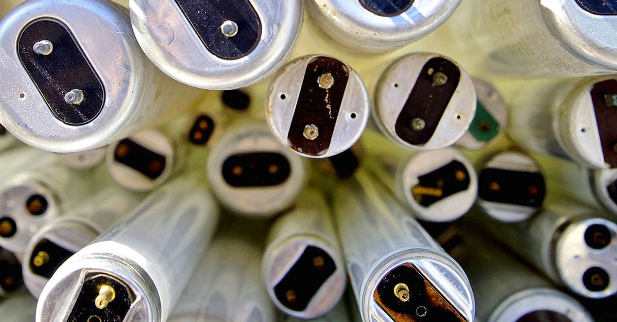 A collection of various discarded compact fluorescent tube lights.