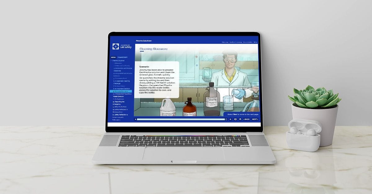 A laptop is sitting on a table next to a potted plant.