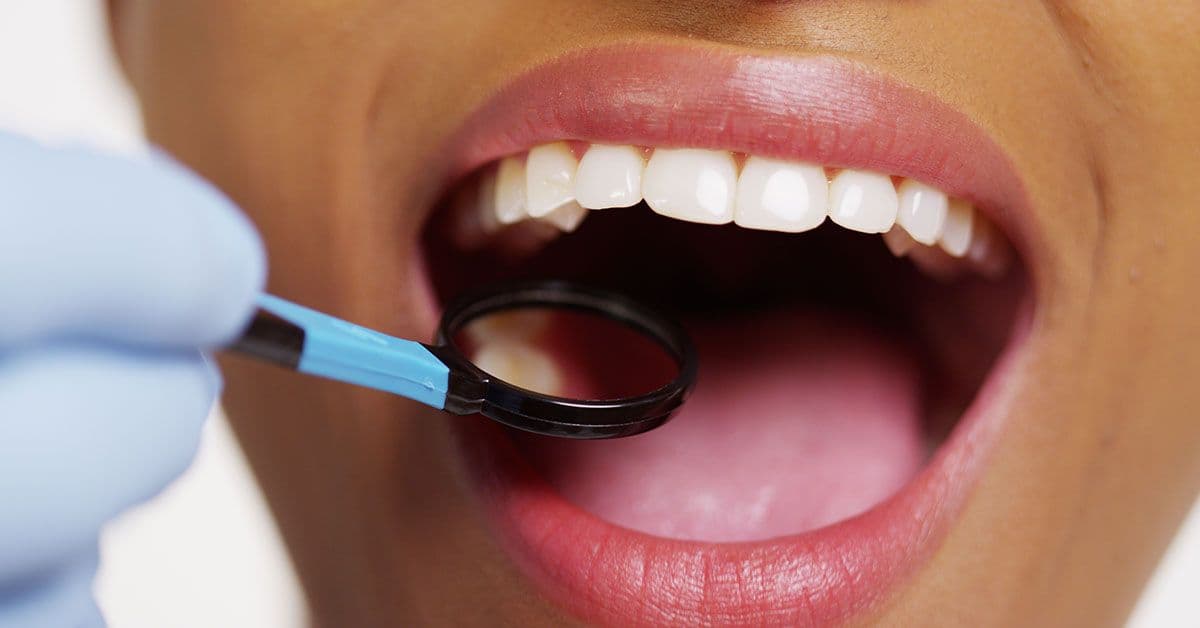 A close up of a woman's mouth with a magnifying glass.