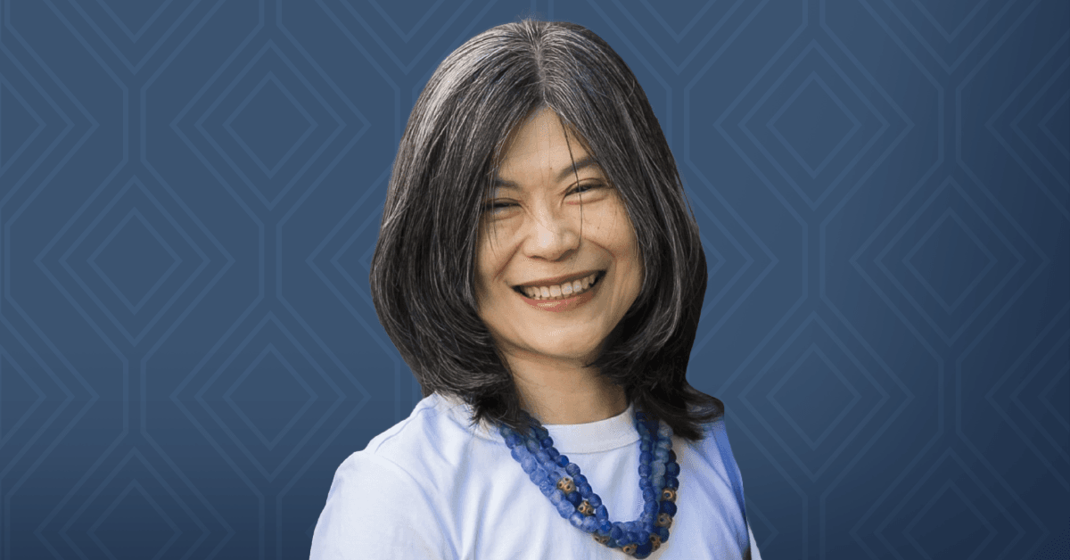 A headshot of Professor Suzie H. Pun against a dark blue background.