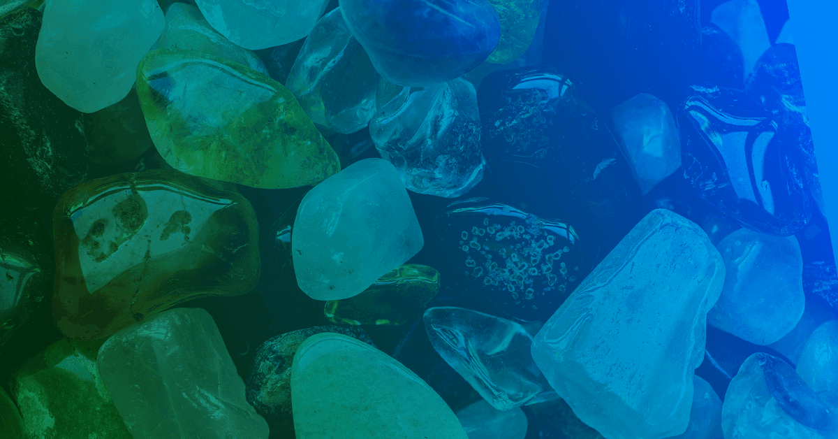 A Close up image of of a pile of green and blue "sea glass" rock