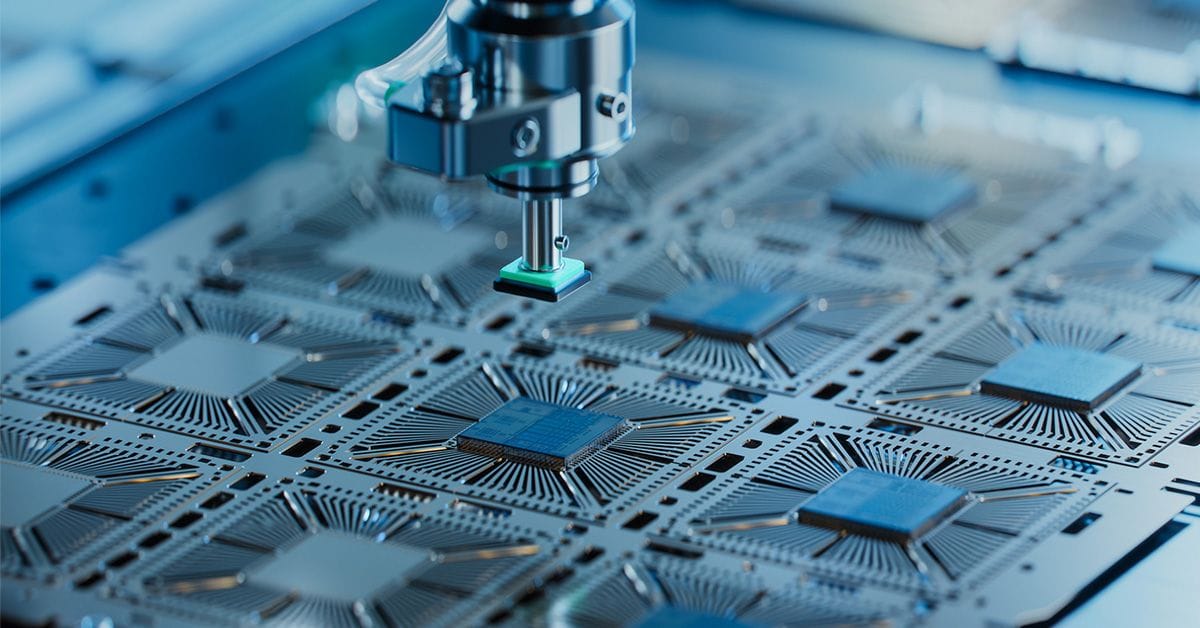 A machine is actively working on electronic circuitry, showcasing advanced technology in electronics manufacturing.