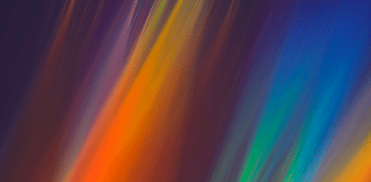 An abstract image featuring vibrant streaks of colors, including red, orange, yellow, green, and blue, on a dark background.