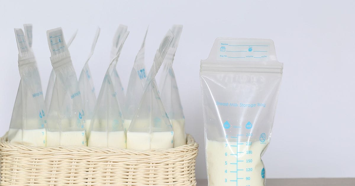 a collection of breast milk in individually portioned freezable bags, sitting in a woven basket.