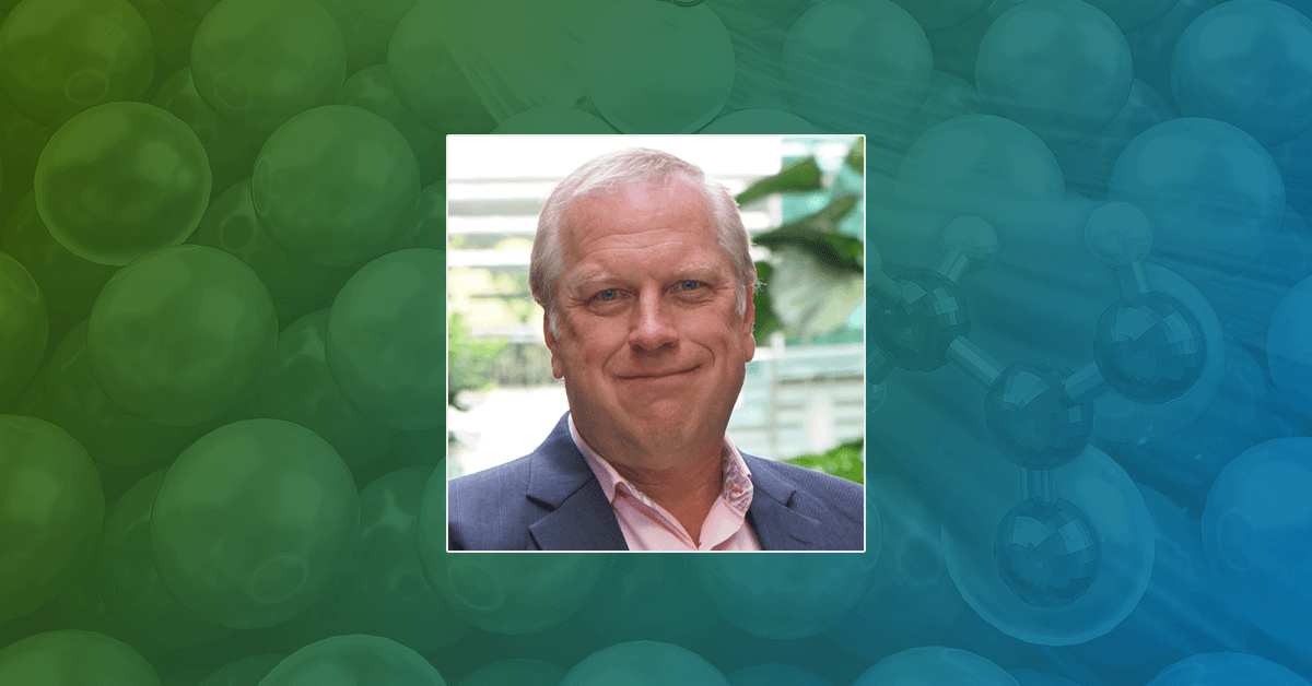 A headshot of Editor-in-Chief Shane Snyder on a green and blue background