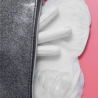 A zipper dividing two contrasting textures with feminine hygiene products on a pink background.