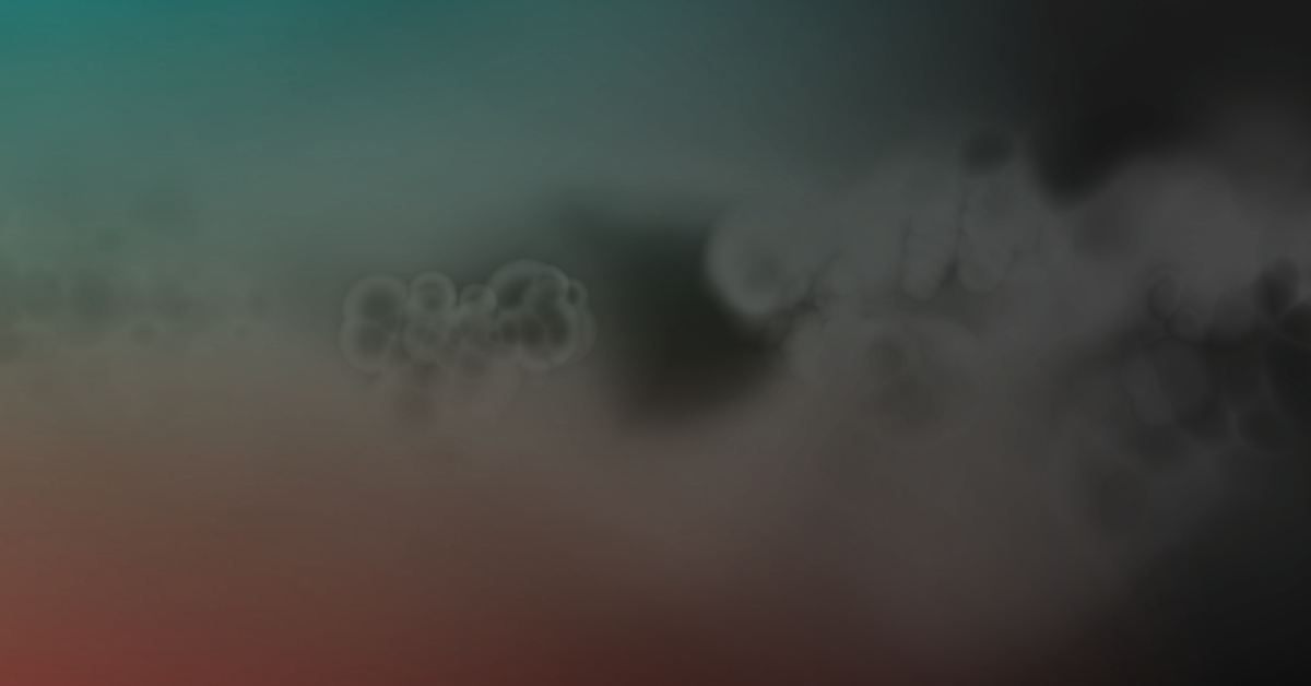 Abstract blurry background with a gradient transition from teal to dark gray, featuring small bubble-like patterns on the right side.