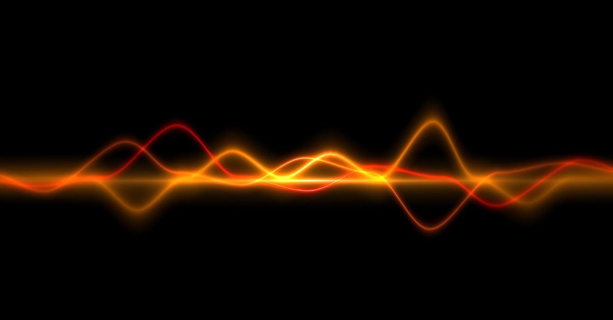 A digital depiction of sound waves and frequencies, using bright wavy lines in shades of orange and yellow.