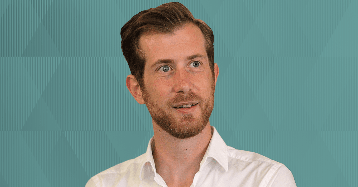 A headshot of Prof. Arnaud Thevenon against a light teal background.