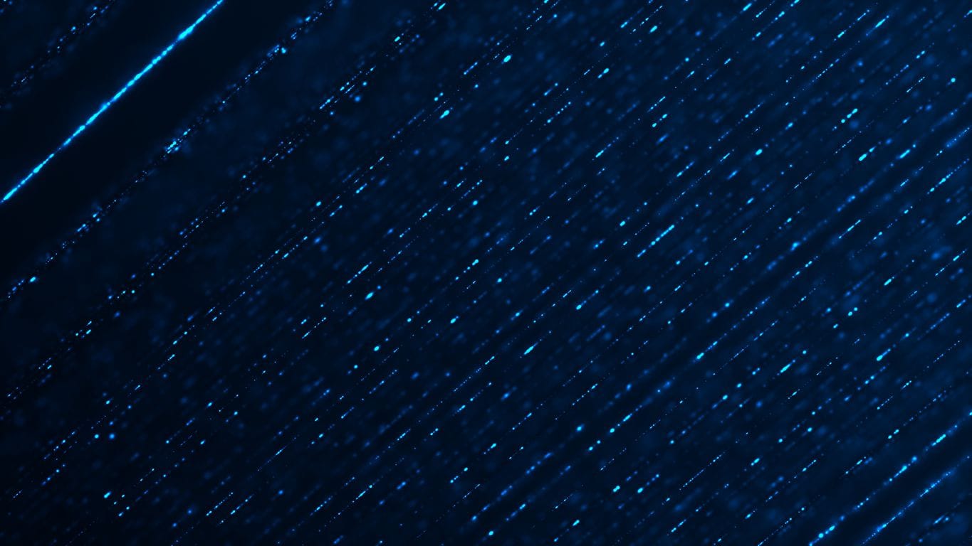 Abstract image of diagonal blue light streaks and glowing particles moving across a dark background