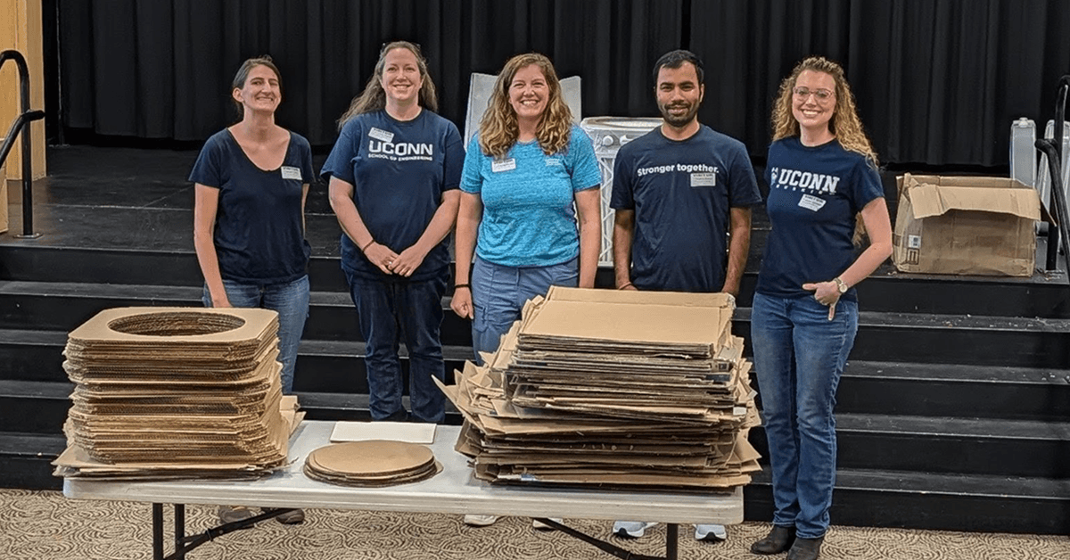Members of the UConn Indoor Air Quality Initiative, including Misti Levy Zamora (right), with cut cardboard components ready for assembling DIY Corsi-Rosenthal Box air filters.