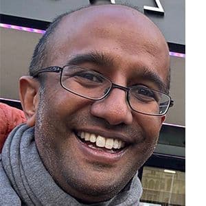 A headshot of Aran Singanayagam