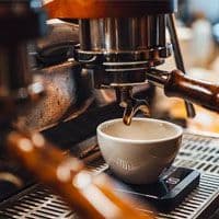 A coffee machine is being used to make a cup of coffee.