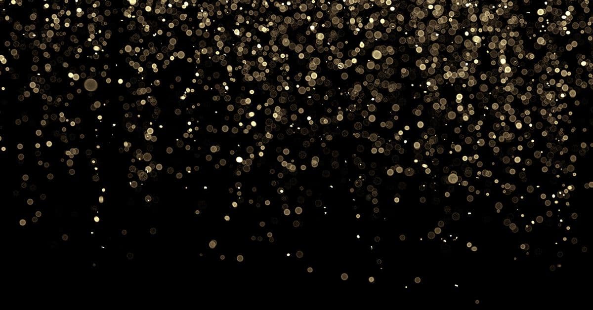 Golden sparkles on a black background.