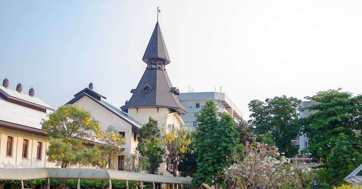 Campus area of Thammasat University in Bangkok Phra Nakhon. Univeristy is located between and near Chao Phraya river and Sanam Luang. In far background a few thai students are walking